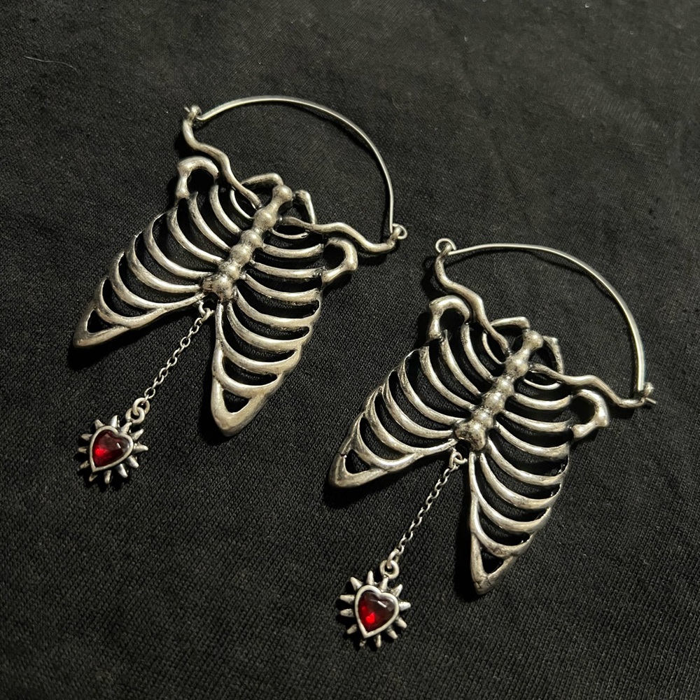 Rib cage with dangling jewel earrings